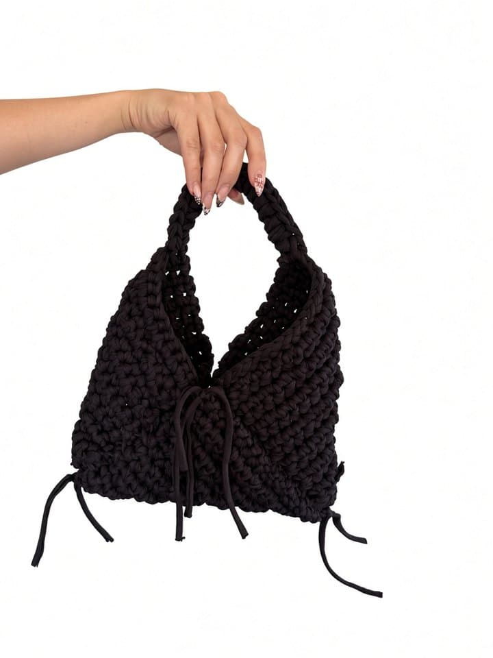 The Allure bag held in hand