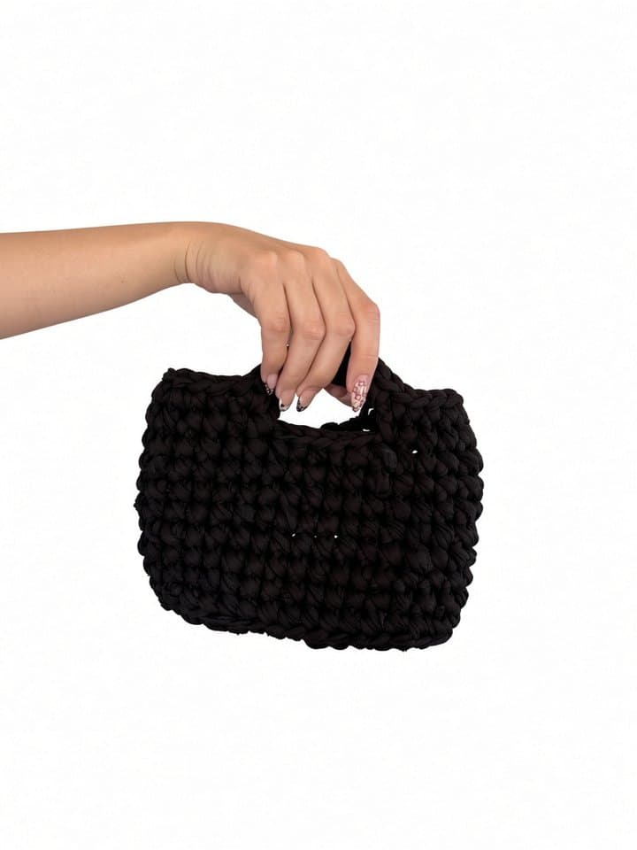 The Cove bag held in hand