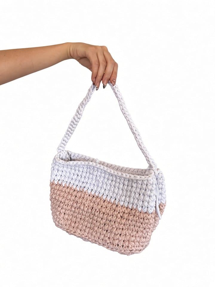 The Lola bag held in hand