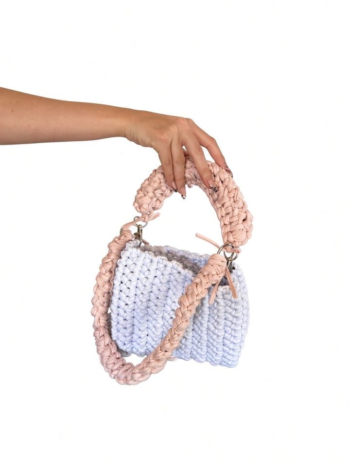 The Luxe bag held in hand