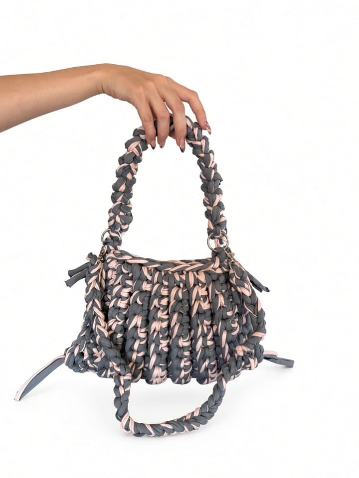 The Nova bag held in hand