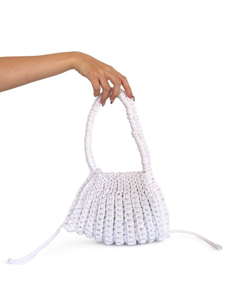 The Ruche bag held in hand